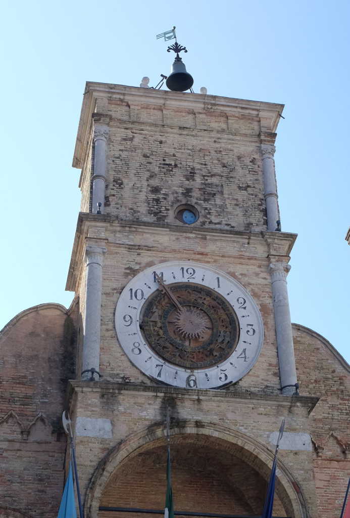 A close-up of the clock tower on Pordenone's Communal Palace.